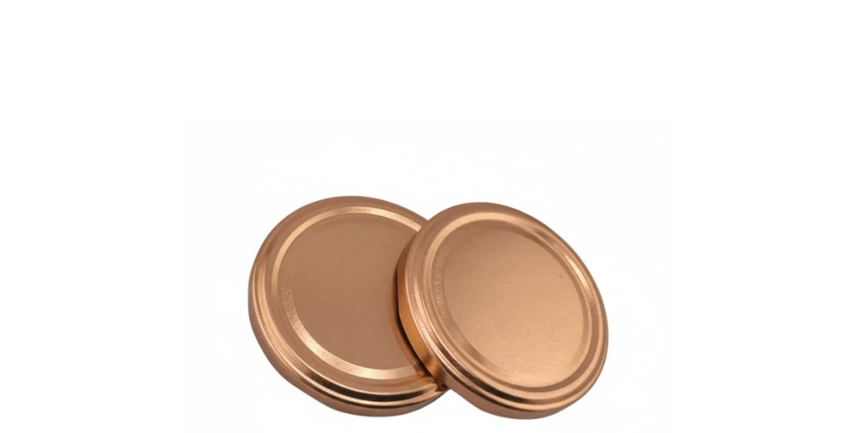 Copper twist-off jar lids, round metal caps for glass containers, on white background